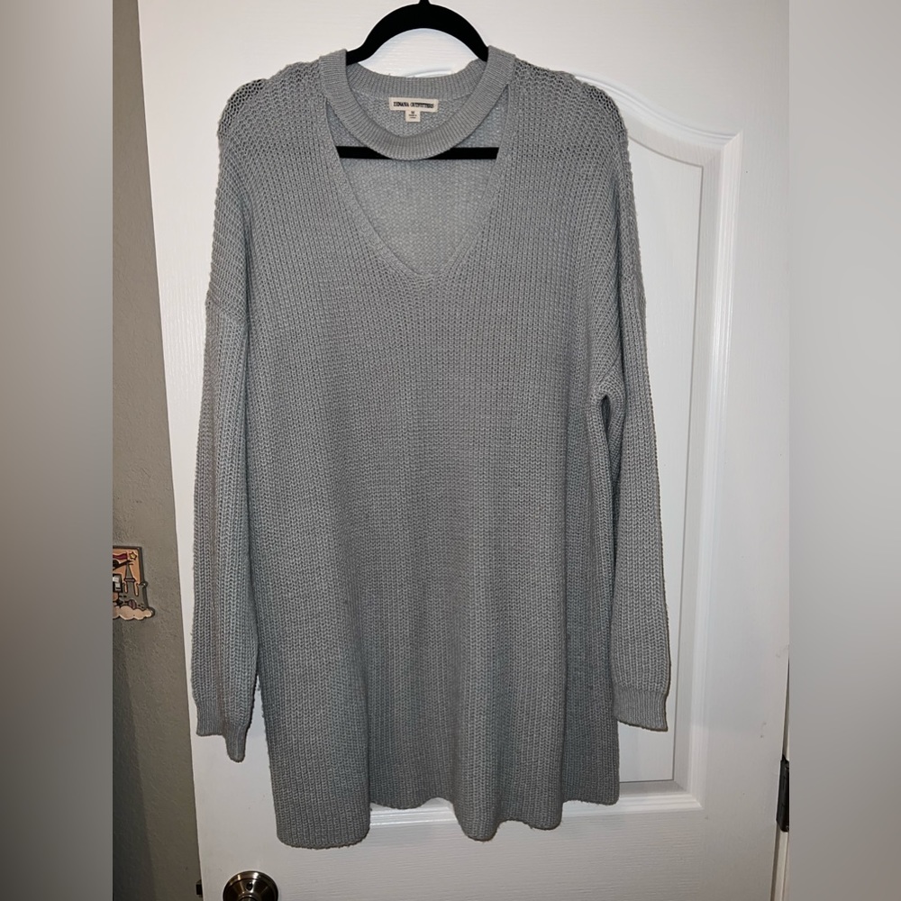 Light blue sweater dress with keyhole cutout. Slight snag. Lightly worn. Size M